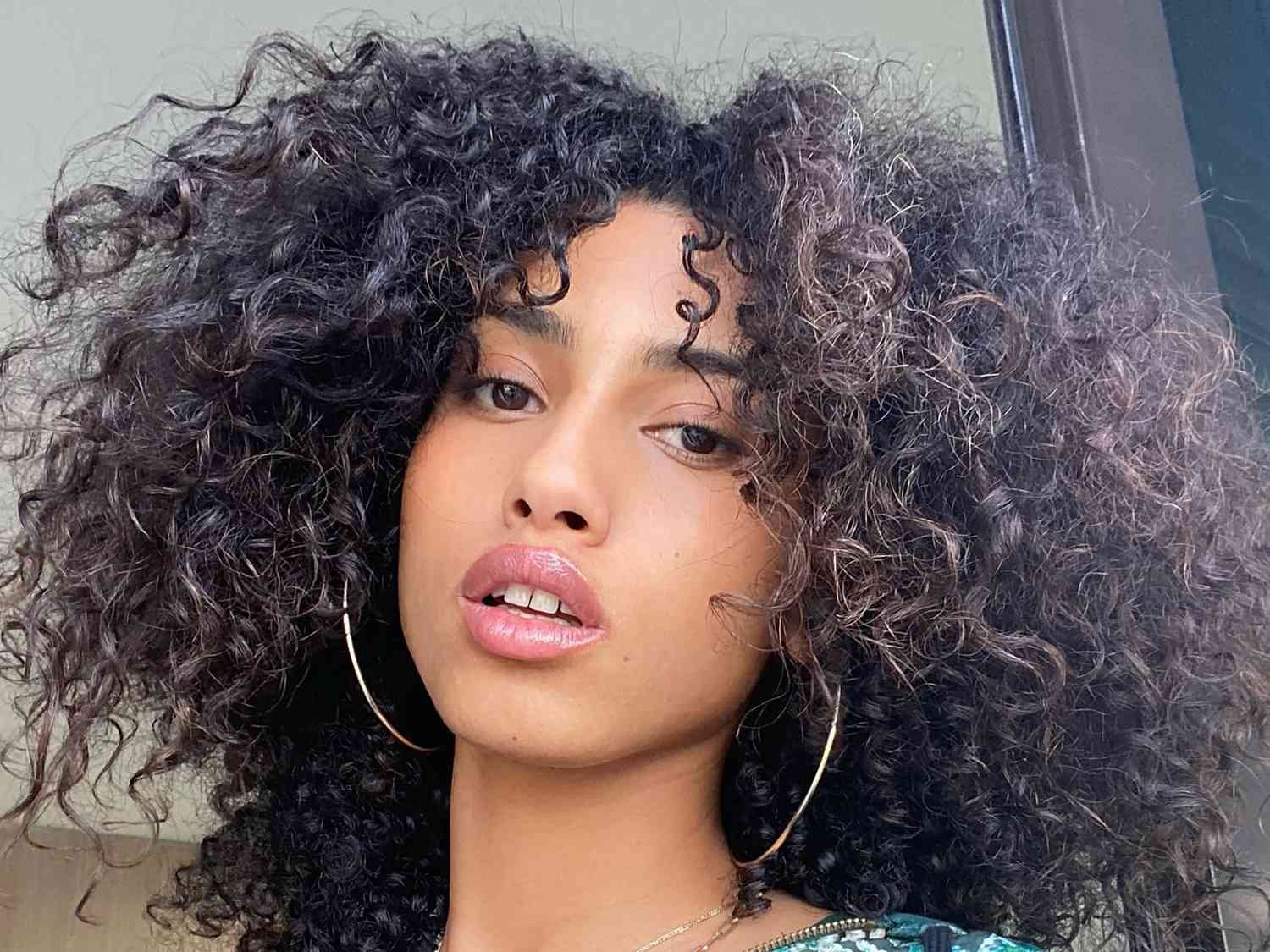 Close up of model Imaan Hammam with her natural curly hair 